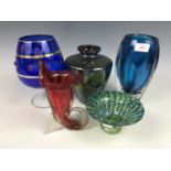 A blue studio glass vase together with an iridescent vase and three others