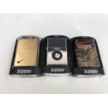 Three cased Zippo lighters, including No. 204PL BR FIN Brass Pipe, No. 452 Real Tree X-Tra Grey
