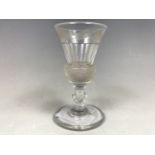 An early 19th Century pre-gadget finely cut thistle-form wine glass, having a polished pontil and