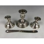 A pair of diminutive silver candlesticks (one a/f) together with a silver Victorian candlestick