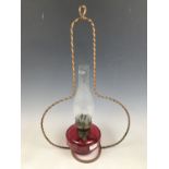 A pendant cranberry glass oil lamp