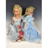 A pair of 1940s composition dolls with flaxen hair and finely pencilled eyebrows