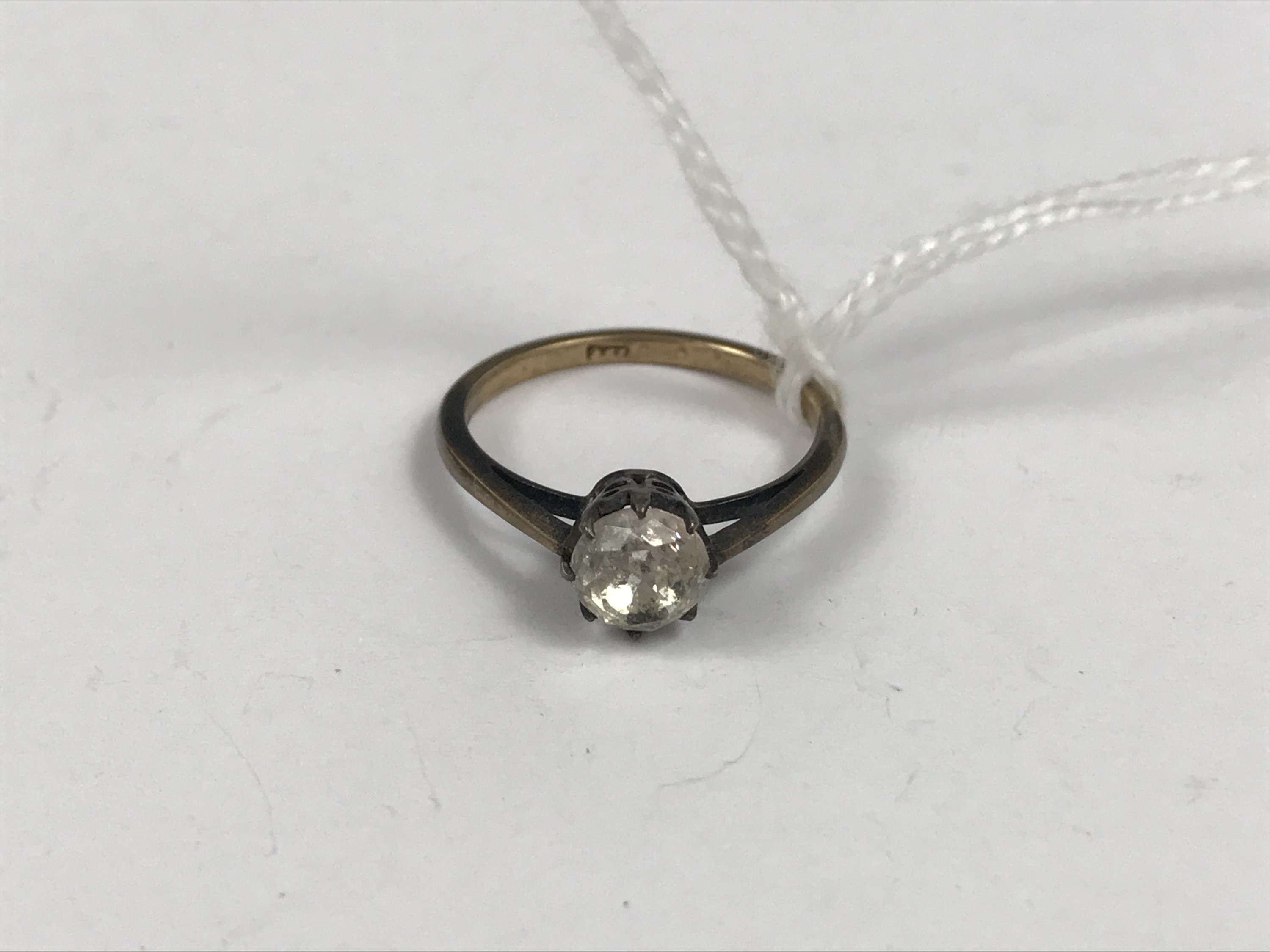 A vintage 9ct gold and paste solitaire, the stone crown set above a cathedral shank, 1.8g