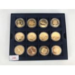 A cased set of twelve Elizabeth II The Crown Jewels Collection 5 crown coins, being 24ct gold plated