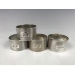 Three Harrison Brothers silver napkin rings together with a Crisford & Norris silver napkin ring