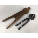 A Black Forest carved wooden nut cracker together with an antique cast-iron nut cracker