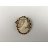 A vintage yellow-metal and cameo brooch, bearing the carved profile of a young lady with coiffured