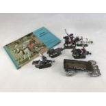 A painted die-cast lead 18th Century toy soldier group together with a book on "Military
