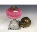 A cast metal and pink opaline glass oil lamp base, together with a brass reservoir