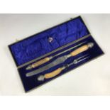 A cased antler handled carving set retailed by DM Dickinson