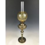 A brass and amber glass oil lamp 77 cm