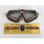 A set of vintage flying / driving goggles and a luminous wrist compass on original packaging