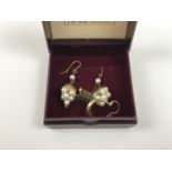 A pair of 9ct gold stud earrings in the form of a maple leaf together with one further pair of