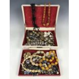 A jewellery box containing vintage costume jewellery including a horn bead necklace, a French jet