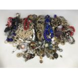A large quantity of costume jewellery necklaces and clip-on earrings