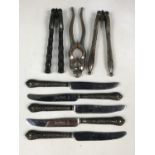 Five silver-handled tea knives together with electroplate nut crackers