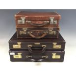 Two briefcases together with two smaller cases