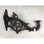 An antique style cast metal sconce