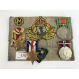 A Second World War Royal Navy campaign medal group together with a related hand-embroidered pouch