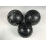 Three black marble carpet bowls