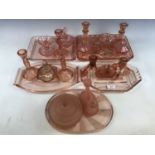 Five 1920s and later pink pressed-glass dressing table sets