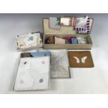 An embroidered fan box containing a quantity of vintage handkerchiefs, together with one further