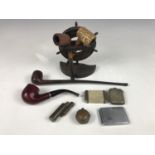 Vintage smoking paraphernalia including a nautical pipe rack modelled as a ships wheel, pipes, vesta