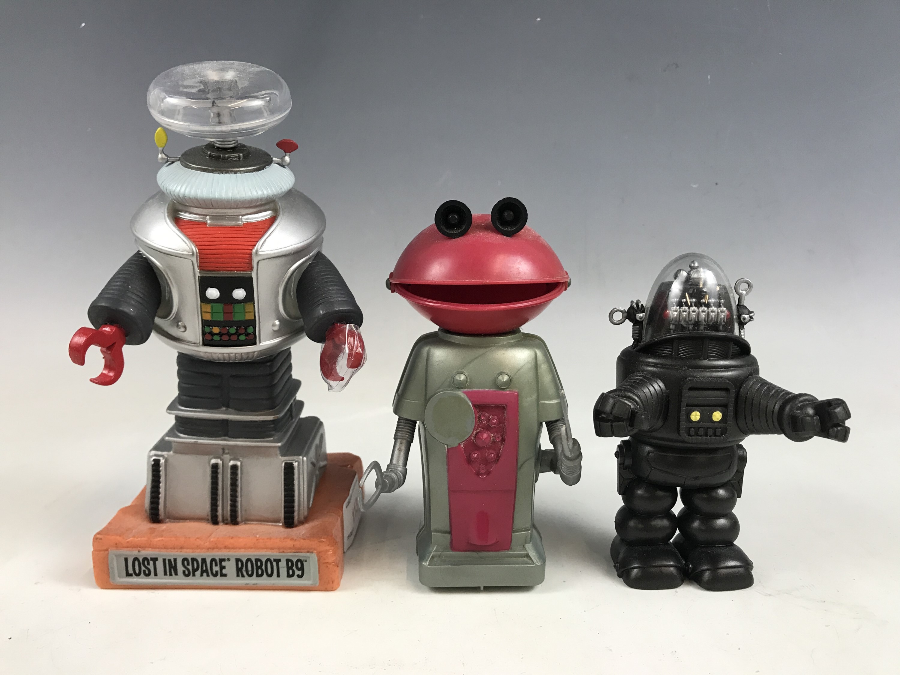 A retro Mr Smash clockwork robot together with two other robot models