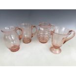 Four early 20th Century hand blown glass lemonade / water jugs