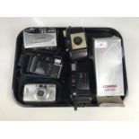 A Kodak Brownie 127 camera together with a Minolta AF.E camera, a Canon Supershot 150U camera, a