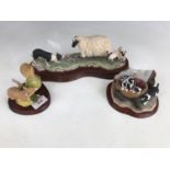 A Border Fine Arts figurine of a collie dog, ewe and lambs (a/f small chip to one horn) together