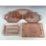 1920s and later pink pressed-glass dishes / trays, including an opaque dish decorated with angel