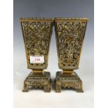 A pair of Aesthetic Movement reticulated brass vases, decorated with song birds amid foliage, late