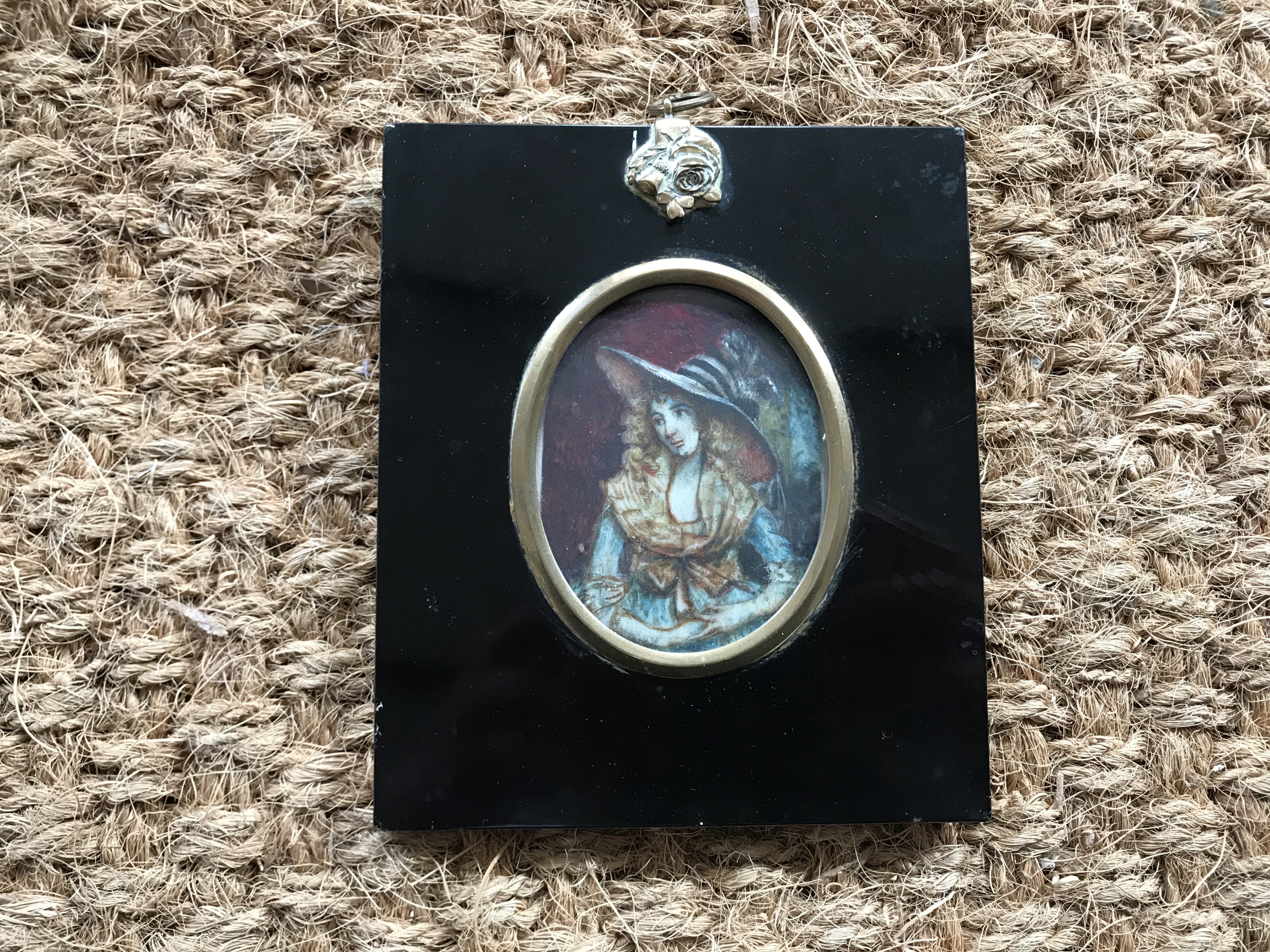 A portrait miniature of a lady in 18th Century dress, watercolour, framed under glass, 7.5 x 6 cm