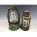 A vintage Gael Brooder paraffin lamp together with one other