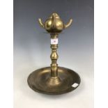 A brass olive oil lamp