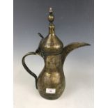 An Islamic brass ewer / pot, 38 cm