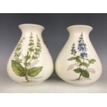 A pair of Poole Pottery "Country Lane" pattern botanical baluster vases, 21 cm