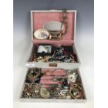 A costume jewellery box containing a large quantity of vintage costume jewellery, including