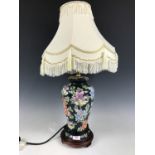 A contemporary blossom patterned table lamp