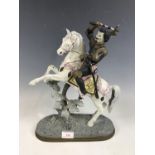 A continental spelter figurine modelled as a knight on a rearing horse