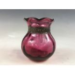 An antique silver-mounted cranberry glass vase