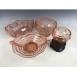 Early 20th Century pink pressed-glass table centrepieces, one being raised over a black pressed-