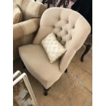 A pair of contemporary beige upholstered button-back chairs