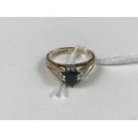 A 9ct gold, sapphire and diamond dress ring, the sapphire being crown and pellet set, the shank