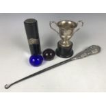 A George V silver trophy cup together with a silver handled button hook and a silver mounted and