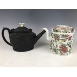 A late Georgian black basalt tea pot (a/f), together with a late Quing Chinese famille rose tea pot