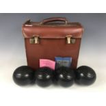 A cased set of Thomas Taylor of Glasgow Tayloid indoor bowls