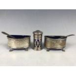 A pair of Edwardian silver salts, of lenticular section, raised over four paw feet, Birmingham,