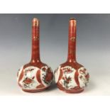 A pair of early 20th Century Japanese Kutani porcelain bottle vases, character marks to bases, 15